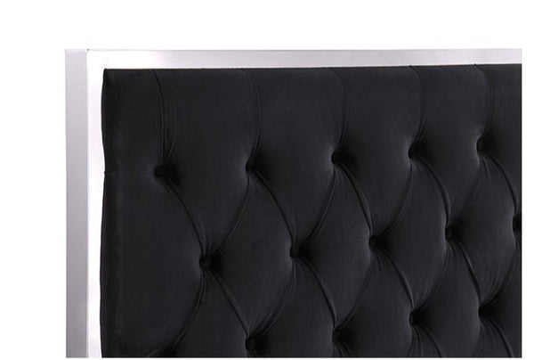 Vasiko Contemporary Glam Chrome Black Fabric Bed A close-up of a black tufted upholstered headboard with a white frame against a white background.