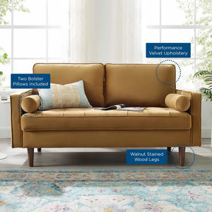 Vaspire Modern Cognac Velvet Performance Loveseat Brown sofa with bolster pillows and wooden legs in a room with large windows and plants.
