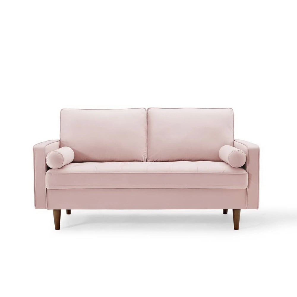 Vaspire Modern Pink Velvet Performance Loveseat Pink sofa with a pillow in a bright room with large windows and plants.