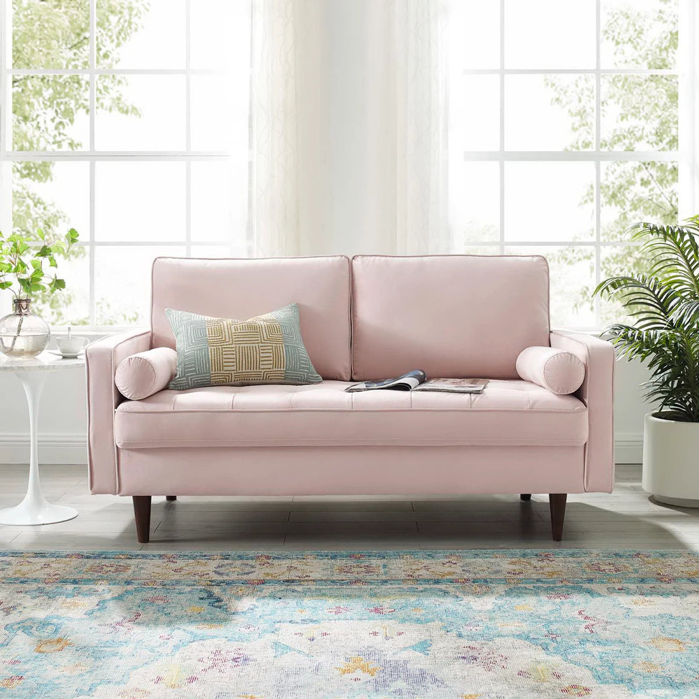 Vaspire Modern Pink Velvet Performance Loveseat Pink sofa with a pillow in a bright room with large windows and plants.