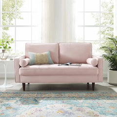 Vaspire Modern Pink Velvet Performance Loveseat Pink sofa with a pillow in a bright room with large windows and plants.
