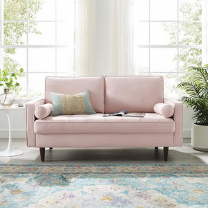 Vaspire Modern Pink Velvet Performance Loveseat Pink sofa with a pillow in a bright room with large windows and plants.