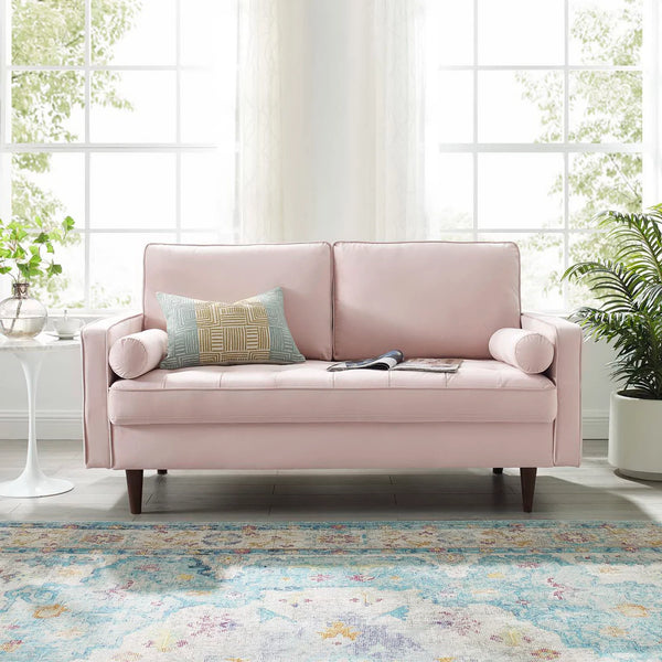 Vaspire Modern Pink Velvet Performance Loveseat Pink sofa with a pillow in a bright room with large windows and plants.