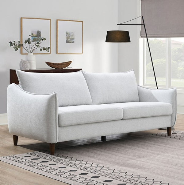 Veron Skinny Slope Arm Sofa Light Gray White sofa in a living room with a wooden floor and large windows.