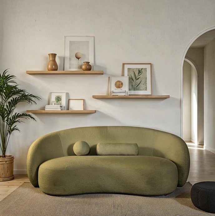 Vika Sofa Curved Back and Arm Olive Green Modern olive green sofa in a living room with shelves and decor.