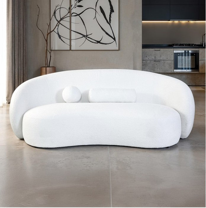 Vika Curved Back and Arm White Chenille Sofa Modern white sofa in a living room setting with a kitchen in the background.