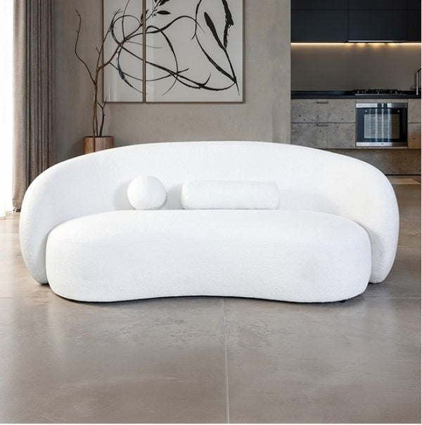 Vika Curved Back and Arm White Chenille Sofa Modern white sofa in a living room setting with a kitchen in the background.