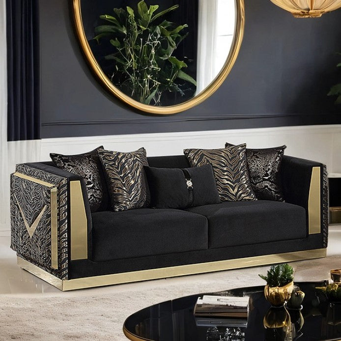 Vikki Black Gold Velvet Glam Sofa Black sofa with gold accents in a stylish room with a mirror and decor.