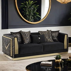 Vikki Black Gold Velvet Glam Sofa Black sofa with gold accents in a stylish room with a mirror and decor.