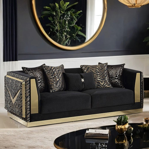 Vikki Black Gold Velvet Glam Sofa Black sofa with gold accents in a stylish room with a mirror and decor.