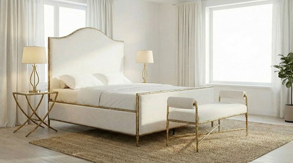 Vilber Matte Gold Fully Upholstered Bed Neatly arranged bedroom with a white bed, gold nightstands, and bench.