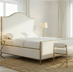 Vilber Matte Gold Fully Upholstered Bed Neatly made bed with gold frame in a bright bedroom