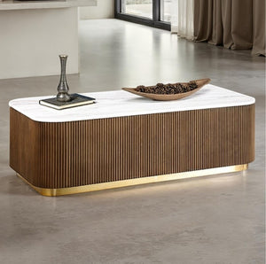 Modern coffee table with marble top and wooden base in a room setting