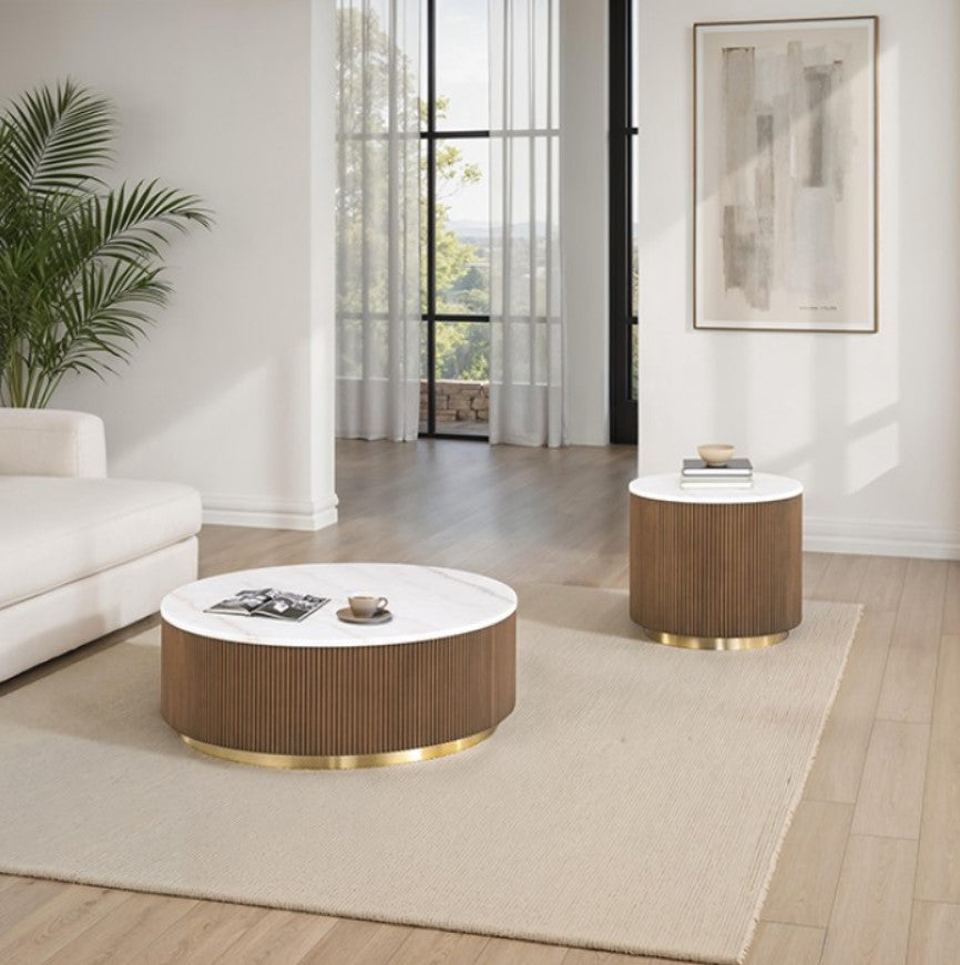 Round coffee table with a white top and brown ribbed base in a living room setting.