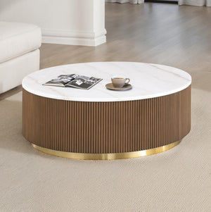 Round coffee table with a white top and brown ribbed base in a living room setting.