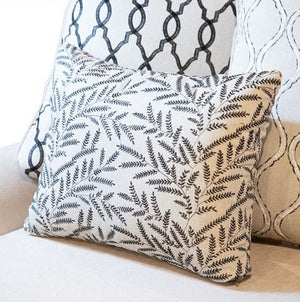 Decorative pillows with leaf pattern on a sofa