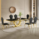 #Black & Gold  Dining room set with a black and gold table and chairs in a modern interior.