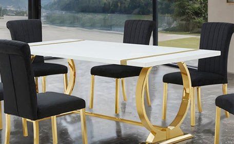 Dining table with gold legs and black chairs in a modern setting